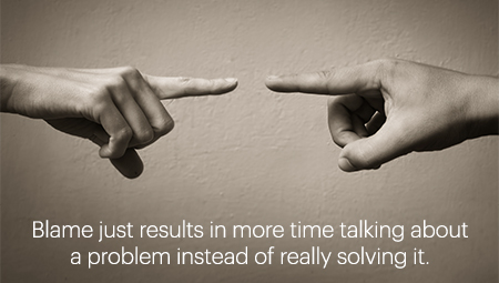 sepia image close up of 2 peoples hands pointing at each other with call out text: Blame just results in more time talking about a problem instead of really solving it.