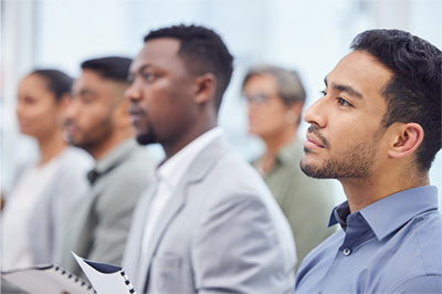 staff meeting showing attendees with serious faces