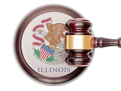 Gavel suspended above an Illinois State legislative symbol