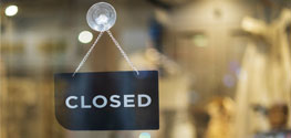 Closed sign hanging on door of business